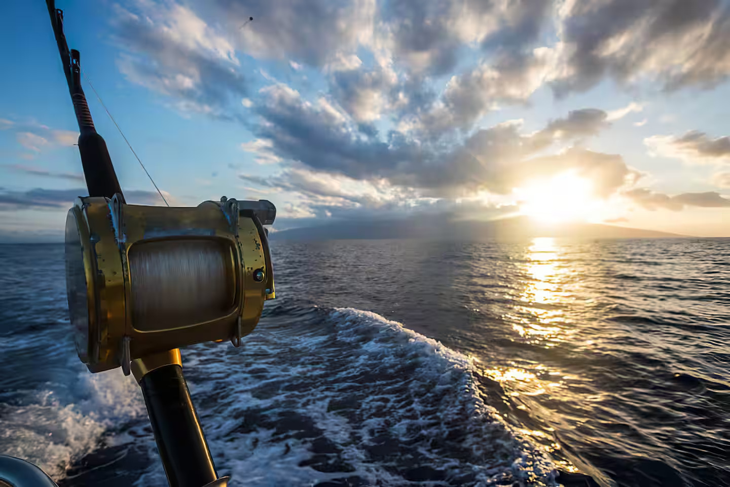 Deep sea fishing boat reel at golden-hour sunset off the Florida coast
